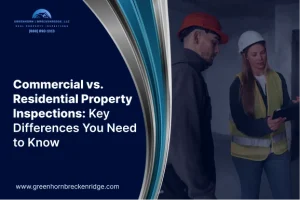 Inspectors in hard hats reviewing a digital tablet inside a building under construction for a property inspection.