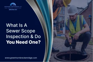 Two inspectors in safety vests using a camera probe to perform a sewer scope inspection on a residential property.