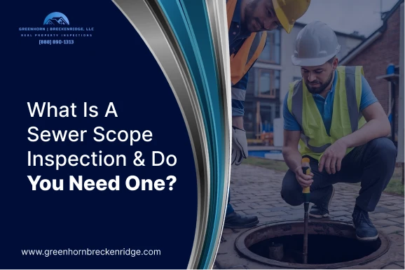 Two inspectors in safety vests using a camera probe to perform a sewer scope inspection on a residential property.